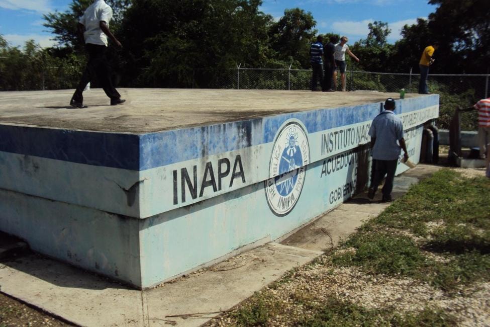 Engineers and community members inspecting the INAPA water storage tank