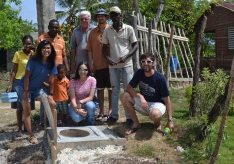 Volunteer measuring a well in a partner community